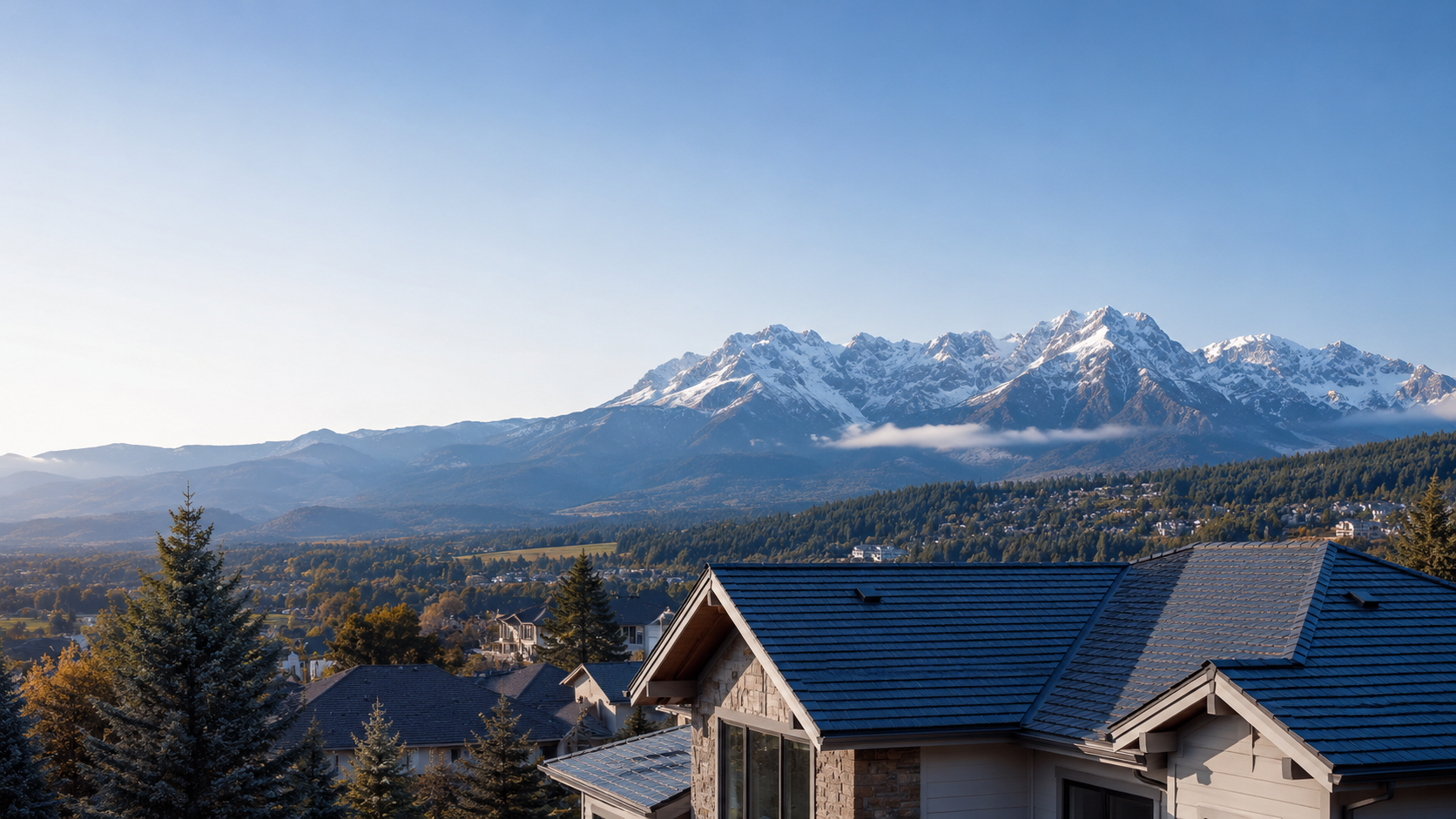Snow-capped Front Range peaks above shingled rooftops in a Littleton, Colorado neighborhood